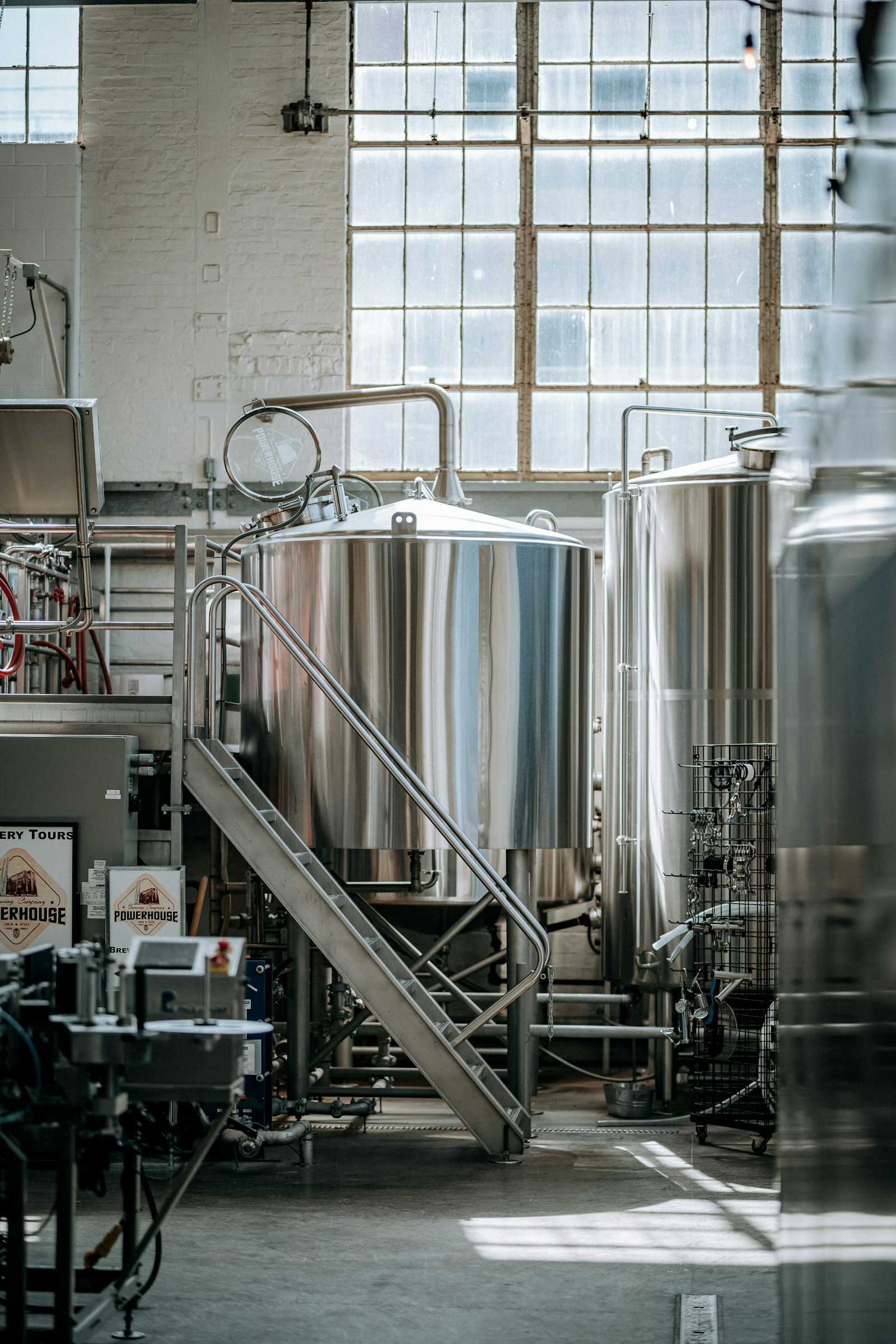 Stainless steel fermentation tanks inside a craft brewery