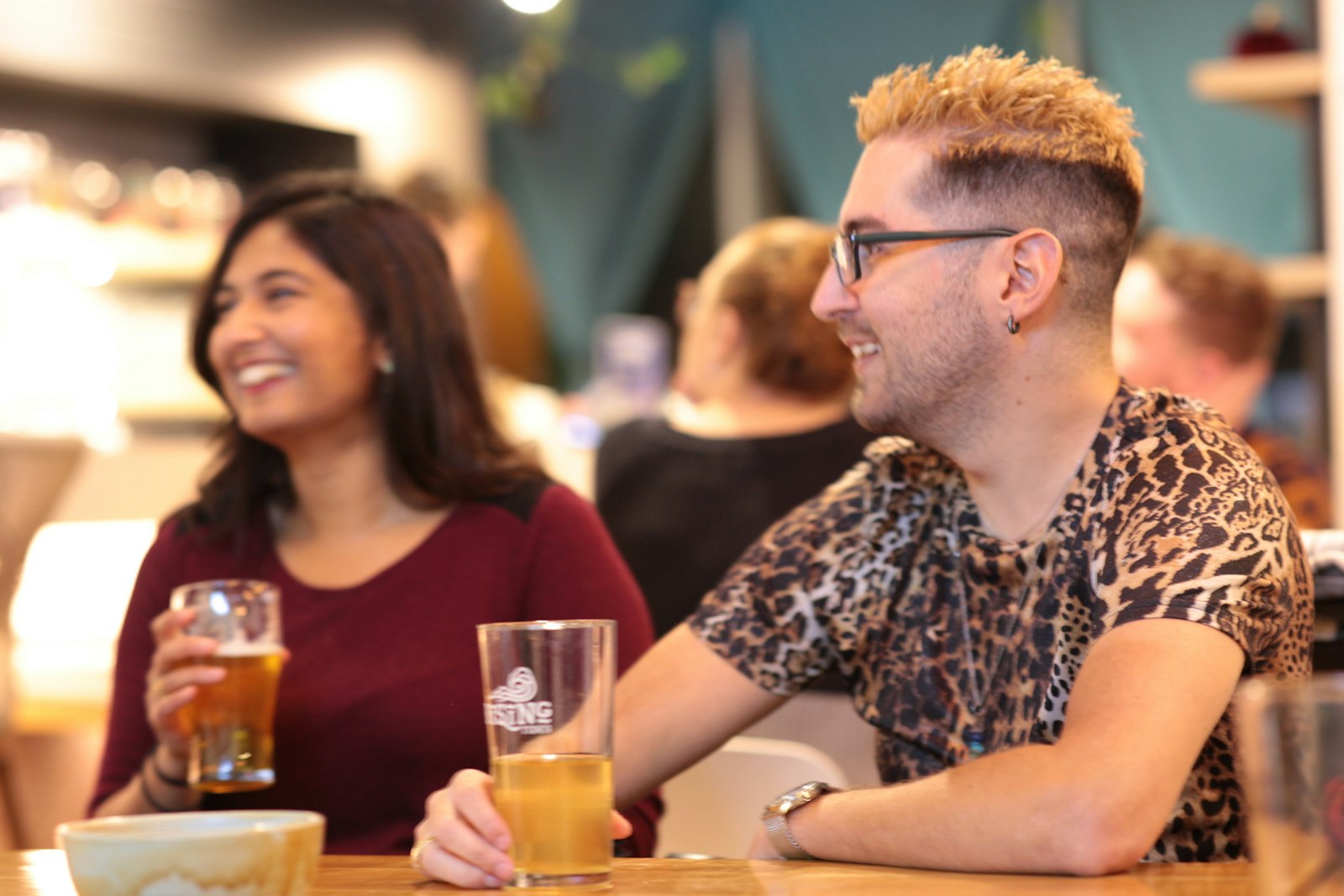 Friends sharing craft beers together around a table